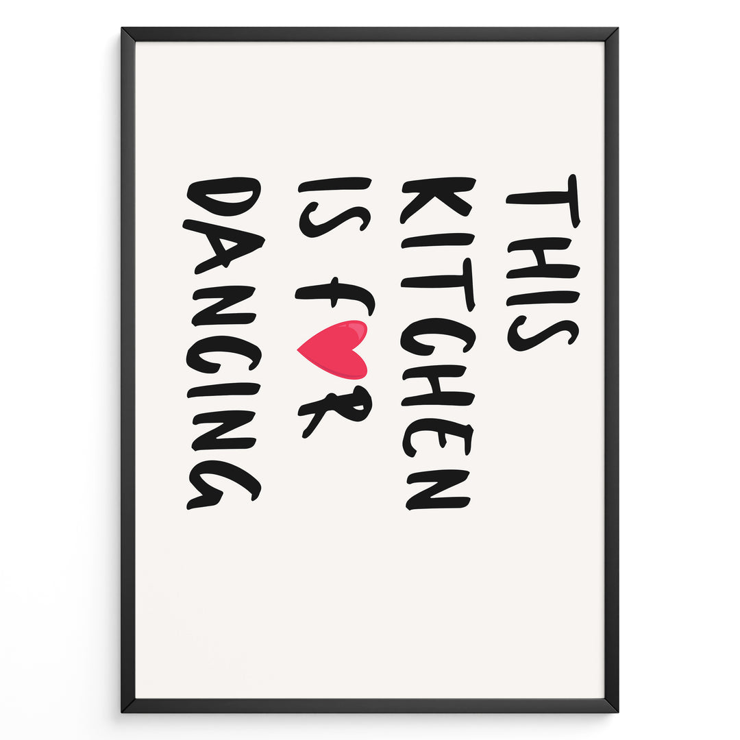 Minimalist poster with text “This Kitchen Is for Dancing” and a red heart in black font, framed in black.