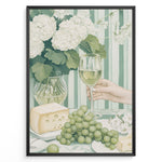 Ladda upp bild till gallerivisning, Elegant art print plakat of white wine glass, grapes, cheese, and hydrangeas on a green striped table with a hand holding a wine glass in a black frame.
