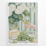 Ladda upp bild till gallerivisning, Elegant art print plakat of white wine glass, grapes, cheese, and hydrangeas on a green striped table with a hand holding a wine glass in a white frame.
