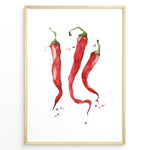 Ladda upp bild till gallerivisning, Watercolor plakat illustration of three red chili peppers with green stems and paint splatters, framed in black, ideal for modern kitchen or dining room décor.
