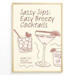 Ladda upp bild till gallerivisning, Minimalist cocktail-themed wall art with line drawings of martini and mojito glasses and the text “Sassy Sips: Easy Breezy Cocktails,” framed in black for kitchen or bar décor.

