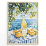 Ladda upp bild till gallerivisning, Limoncello art print plakat with a bottle of limoncello, lemons, and green leaves overlooking the blue sea on a striped tablecloth in a golden frame.
