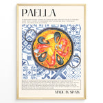 Ladda upp bild till gallerivisning, Watercolor paella wall art showing seafood, rice, and mussels on blue patterned tiles, framed in black, ideal for Spanish kitchen or restaurant wall decoration.
