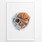 Ladda upp bild till gallerivisning, Watercolor wall art of a croissant and espresso cup on a blue decorative plate, ideal for French café, kitchen, or breakfast nook wall décor.
