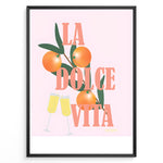 Ladda upp bild till gallerivisning, Stylish La Dolce Vita poster with oranges, green leaves, and champagne glasses on a pink background, framed as Italian-inspired wall art.
