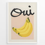 Ladda upp bild till gallerivisning, Modern art poster featuring the word “Oui” in bold black text above a bunch of yellow bananas on a soft pink background, framed as French kitchen wall décor.
