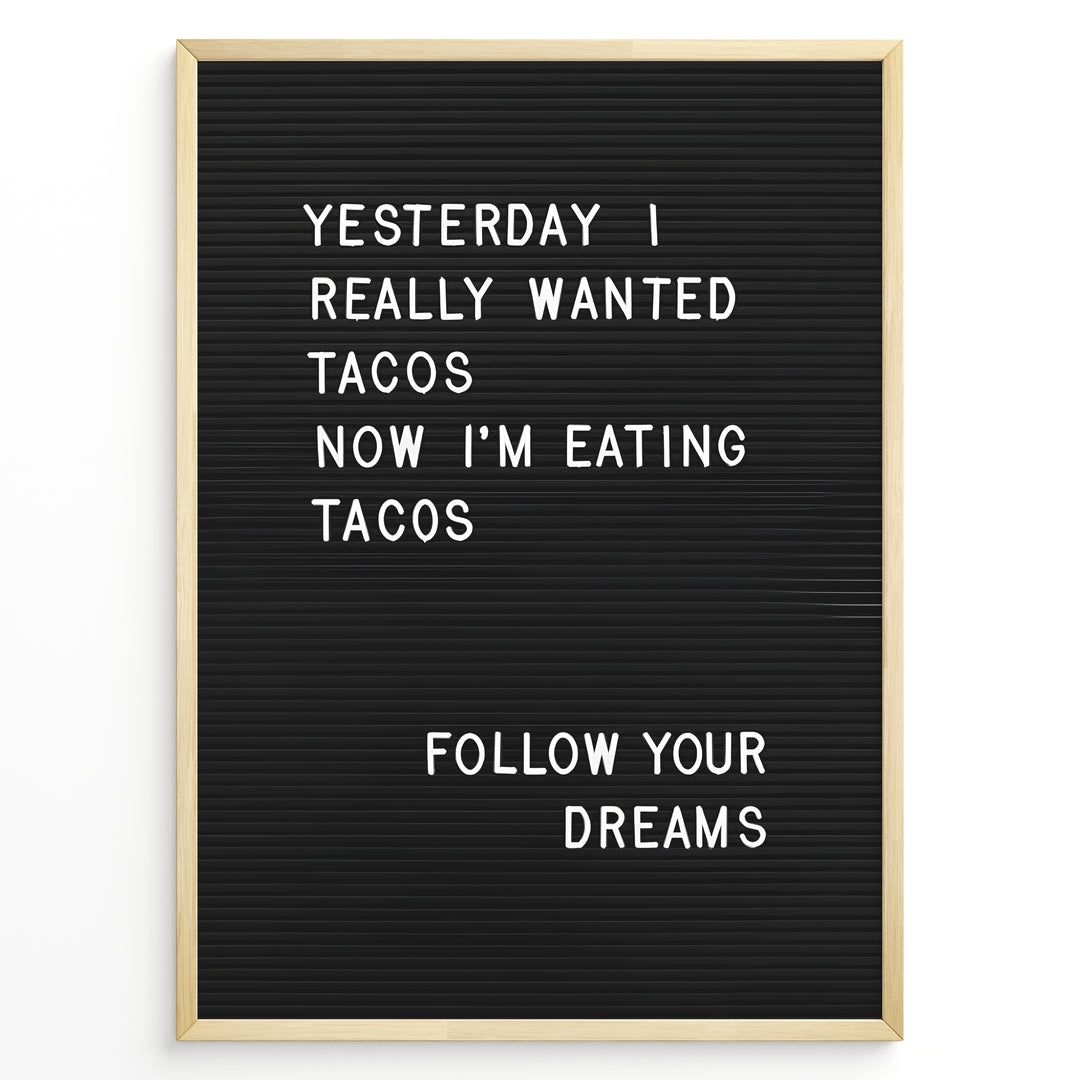 Black letterboard with a funny taco quote that says “Yesterday I really wanted tacos. Now I’m eating tacos. Follow your dreams.”