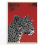 Ladda upp bild till gallerivisning, Illustrated leopard portrait with detailed spots and green eyes on a textured red background, framed in black.
