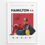 Ladda upp bild till gallerivisning, Framed Hamilton 44 Scuderia Ferrari F1 poster showing the driver in a red suit leaning on tires, holding a yellow helmet, with signature and career stats.
