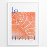 Ladda upp bild till gallerivisning, Le Matin poster with minimalist croissant illustration in orange and blue text on a white background in a white frame.
