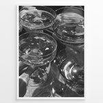 Ladda upp bild till gallerivisning, Fashion Plakat | Cheers in Black &amp; White: Luxe Champagne Coupes Wall Art Plakaty.dk | Black and white photo of multiple champagne coupe glasses being raised in a celebratory toast, reflecting light and bubbles.
