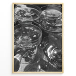 Ladda upp bild till gallerivisning, Fashion Plakat | Cheers in Black &amp; White: Luxe Champagne Coupes Wall Art Plakaty.dk | Black and white photo of multiple champagne coupe glasses being raised in a celebratory toast, reflecting light and bubbles.
