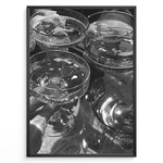 Ladda upp bild till gallerivisning, Fashion Plakat | Cheers in Black &amp; White: Luxe Champagne Coupes Wall Art Plakaty.dk | Black and white photo of multiple champagne coupe glasses being raised in a celebratory toast, reflecting light and bubbles.

