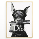 Ladda upp bild till gallerivisning, Fashion Plakat | Dior Guard Dog – Bold Fashion Art Print Plakaty.dk | Black and white image of a Doberman dog holding a handgun in its mouth, wearing a spiked collar with the Dior logo, against a plain background.

