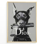 Ladda upp bild till gallerivisning, Fashion Plakat | Dior Guard Dog Poster – Bold Fashion Statement Wall Art Plakaty.dk | Black and white image of a Doberman dog holding a handgun in its mouth, wearing a Dior collar, with &quot;Dior&quot; text overlayed – a bold, edgy luxury fashion print.
