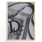Ladda upp bild till gallerivisning, Fashion Plakat | Dior Pendant Necklace – Elegant Black &amp; White Fashion Print Plakaty.dk | Black and white close-up image of a Dior pendant necklace with a metallic chain, showcasing luxury jewelry on a textured background.
