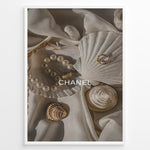 Ladda upp bild till gallerivisning, Fashion Plakat | Elegant Chanel-Inspired Flat Lay with Seashells and Jewelry Plakaty.dk | Flat lay of elegant seashells, a pearl bracelet, and gold jewelry on soft ivory fabric with the Chanel logo centered.
