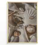 Ladda upp bild till gallerivisning, Fashion Plakat | Elegant Chanel-Inspired Flat Lay with Seashells and Jewelry Plakaty.dk | Flat lay of elegant seashells, a pearl bracelet, and gold jewelry on soft ivory fabric with the Chanel logo centered.
