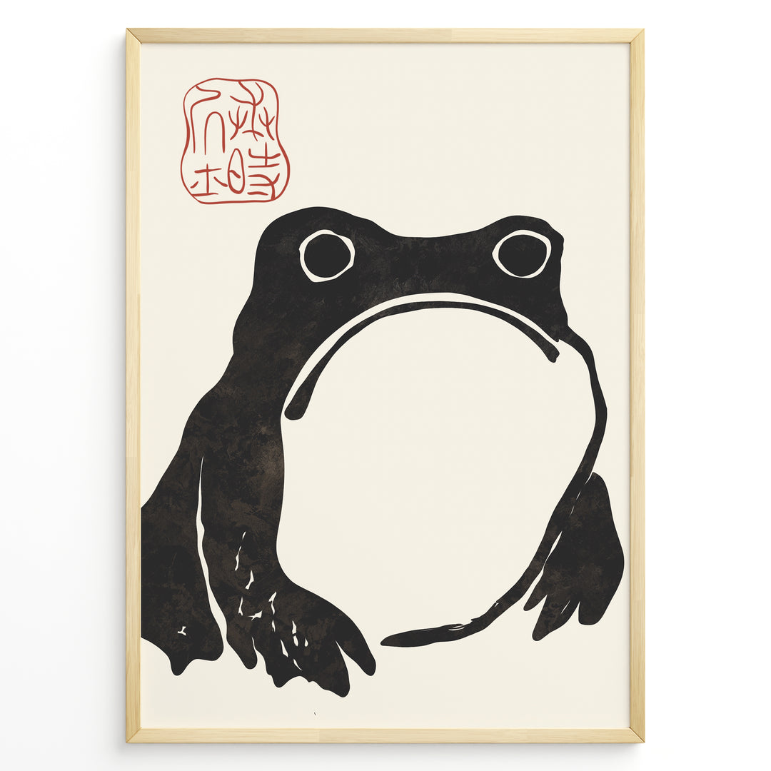 Framed Japanese ink art poster featuring a minimalist black frog illustration with red calligraphy stamp on a beige background.