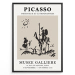 Ladda upp bild till gallerivisning, Framed Picasso Don Quixote art poster with minimalist black sketch of riders and windmills on a beige background.
