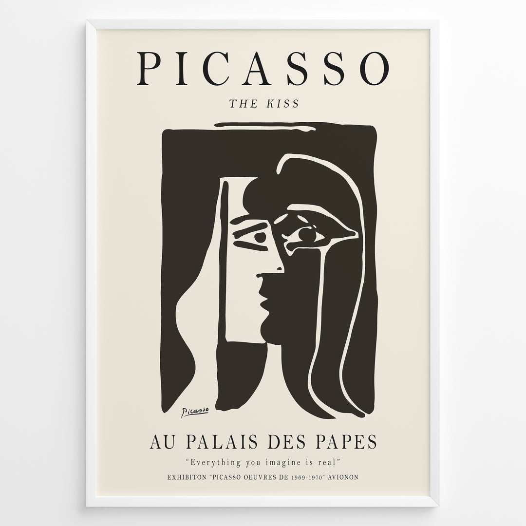 Framed Picasso “The Kiss” poster with two abstract faces in black on a beige background.