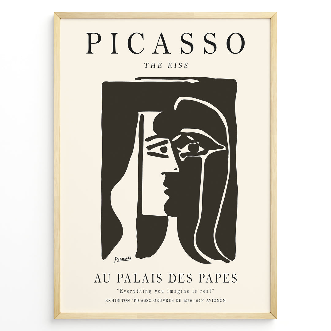Framed Picasso “The Kiss” poster with two abstract faces in black on a beige background.