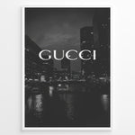 Ladda upp bild till gallerivisning, Fashion Plakat | Gucci Cityscape Black &amp; White Fashion Poster Plakaty.dk | Black and white poster with the Gucci logo over a night cityscape featuring tall buildings and water reflections.
