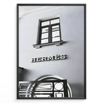 Ladda upp bild till gallerivisning, Fashion Plakat | Hermès Storefront Minimalist Poster – Black &amp; White Fashion Wall Art Plakaty.dk | Black and white photo of the Hermès storefront with a clean minimalist facade, showing a window above the iconic logo and part of an ornate entryway gate.
