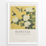 Ladda upp bild till gallerivisning, Japanske plakater | Japanese woodblock print of white trumpet lilies with green leaves and two sparrows flying against a yellow background, based on Hokusai’s  floral artwork.
