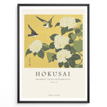 Ladda upp bild till gallerivisning, Japanske plakater | Japanese woodblock print of white trumpet lilies with green leaves and two sparrows flying against a yellow background, based on Hokusai’s  floral artwork.
