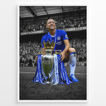 Ladda upp bild till gallerivisning, John Terry wearing a Chelsea football jersey with the Premier League trophy in front of the Chelsea supporters. The iconic blue colors stand out against the black and white stadium background.
