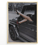Ladda upp bild till gallerivisning, Fashion Plakat | Luxury Escape: Legs in High Heels Through Mercedes G-Wagon Window Plakaty.dk | Woman&#39;s legs in high heels sticking out of a Mercedes-Benz G-Wagon window in an urban street scene.
