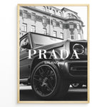 Ladda upp bild till gallerivisning, Fashion Plakat | Luxury Lifestyle: Mercedes G-Wagon x Prada Milano Wall Art Plakaty.dk | Black and white framed photo of a Mercedes G-Wagon with Prada Milano text overlay, parked in front of ornate historic buildings.
