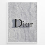 Ladda upp bild till gallerivisning, Fashion Plakat | Minimalist Dior Wall Sign – Timeless Fashion Statement Plakaty.dk | Minimalist black Dior logo mounted on a textured white wall, casting a soft shadow and evoking luxury and elegance.
