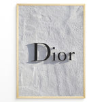 Ladda upp bild till gallerivisning, Fashion Plakat | Minimalist Dior Wall Sign – Timeless Fashion Statement Plakaty.dk | Minimalist black Dior logo mounted on a textured white wall, casting a soft shadow and evoking luxury and elegance.
