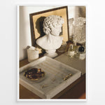 Ladda upp bild till gallerivisning, Fashion Plakat | Modern Vanity Scene with Sculptural Bust, Jewelry, and Perfume – Aesthetic Interior Print Plakaty.dk | Stylish vanity setup with a white classical bust, gold jewelry on a marble tray, designer perfumes, and crystal glassware in warm lighting.
