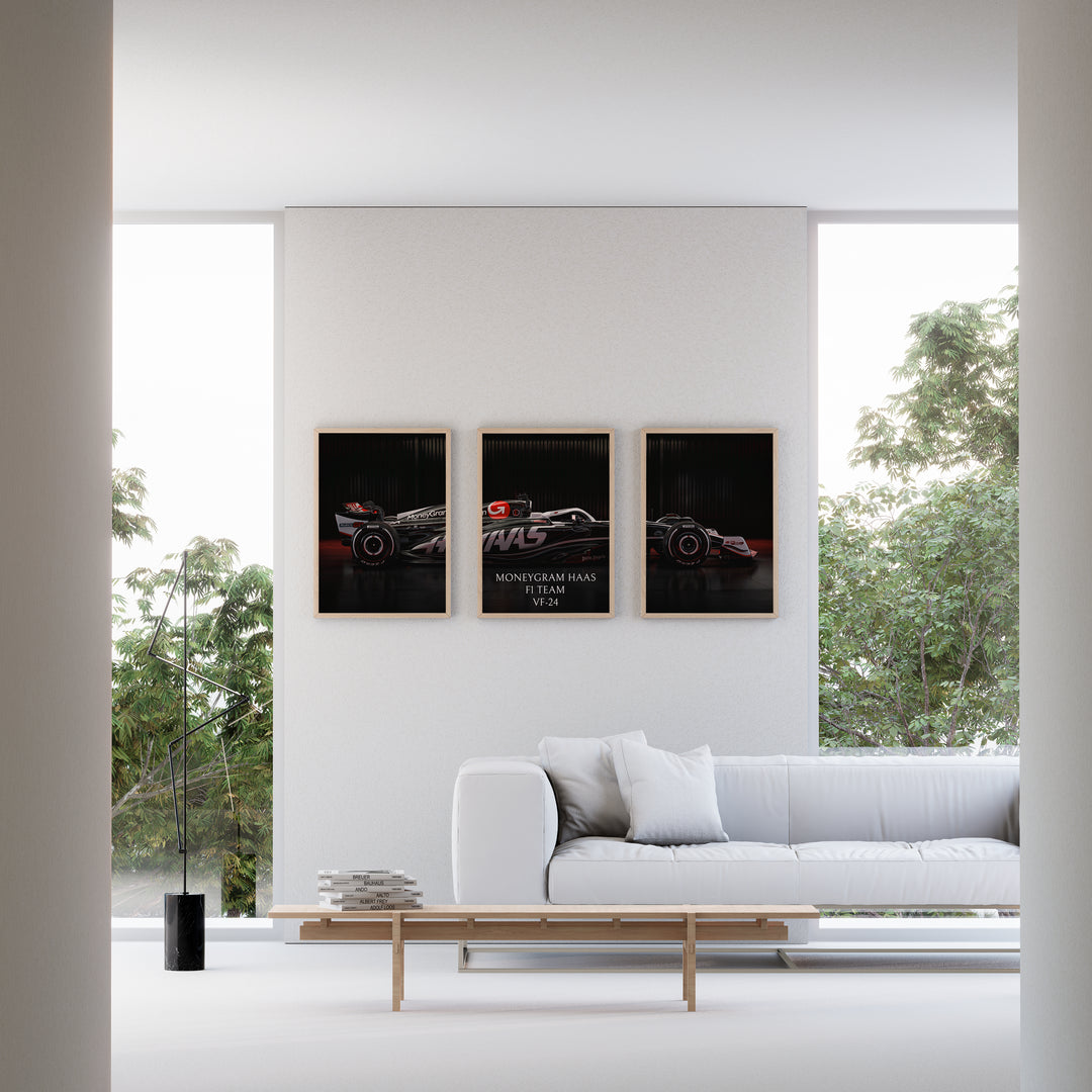 Triptych wall art plakat of the MoneyGram Haas F1 Team VF-24 Formula 1 car displayed in a modern black leather-furnished living room.