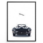 Ladda upp bild till gallerivisning, Framed minimalist poster of a black Jaguar E-Type classic sports car front view with the Jaguar leaping logo above on a white background.
