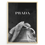 Ladda upp bild till gallerivisning, Fashion Plakat | Prada-Inspired Angel Statue – Fashion and Art Black and White Poster Plakaty.dk | Black and white artwork of a mourning angel statue with the word &quot;PRADA&quot; above, blending classical art and modern fashion
