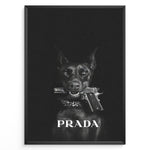 Ladda upp bild till gallerivisning, Fashion Plakat | Prada-Inspired Art Featuring Fierce Dog with Gun Plakaty.dk | Black Doberman with a studded collar holding a handgun in its mouth, set against a dark background with the word &quot;PRADA&quot; in bold white text.
