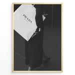 Ladda upp bild till gallerivisning, Fashion Plakat | Prada Shopping Bag Fashion Photography Wall Art Plakaty.dk | Black and white photo of a person holding a large Prada Milano shopping bag, dressed in elegant dark clothing.
