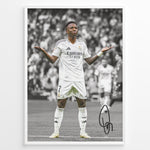 Ladda upp bild till gallerivisning, Framed Plakat of Vinícius Jr. in a Real Madrid kit doing a shrug celebration, with a black and white background and visible signature
