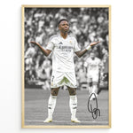 Ladda upp bild till gallerivisning, Framed Plakat of Vinícius Jr. in a Real Madrid kit doing a shrug celebration, with a black and white background and visible signature
