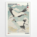 Ladda upp bild till gallerivisning, Japanske plakater | Vintage-style Japanese poster featuring two red-crowned cranes flying in a cloudy sky, with the text &quot;Hokkaido Japan&quot; and traditional Japanese characters referencing a summer festival.
