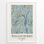 Ladda upp bild till gallerivisning, William Morris Sweet Briar 1887 botanical floral pattern art print with blue and beige leaves and flowers in black frame plakat.
