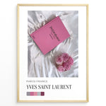 Ladda upp bild till gallerivisning, Fashion Plakat | Yves Saint Laurent Pink Book on Silk – Paris Fashion Decor Plakaty.dk | Yves Saint Laurent pink Catwalk book placed on white silk fabric with pink roses beside it, representing Parisian luxury and soft elegance.
