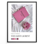 Ladda upp bild till gallerivisning, Fashion Plakat | Yves Saint Laurent Pink Book on Silk – Paris Fashion Decor Plakaty.dk | Yves Saint Laurent pink Catwalk book placed on white silk fabric with pink roses beside it, representing Parisian luxury and soft elegance.
